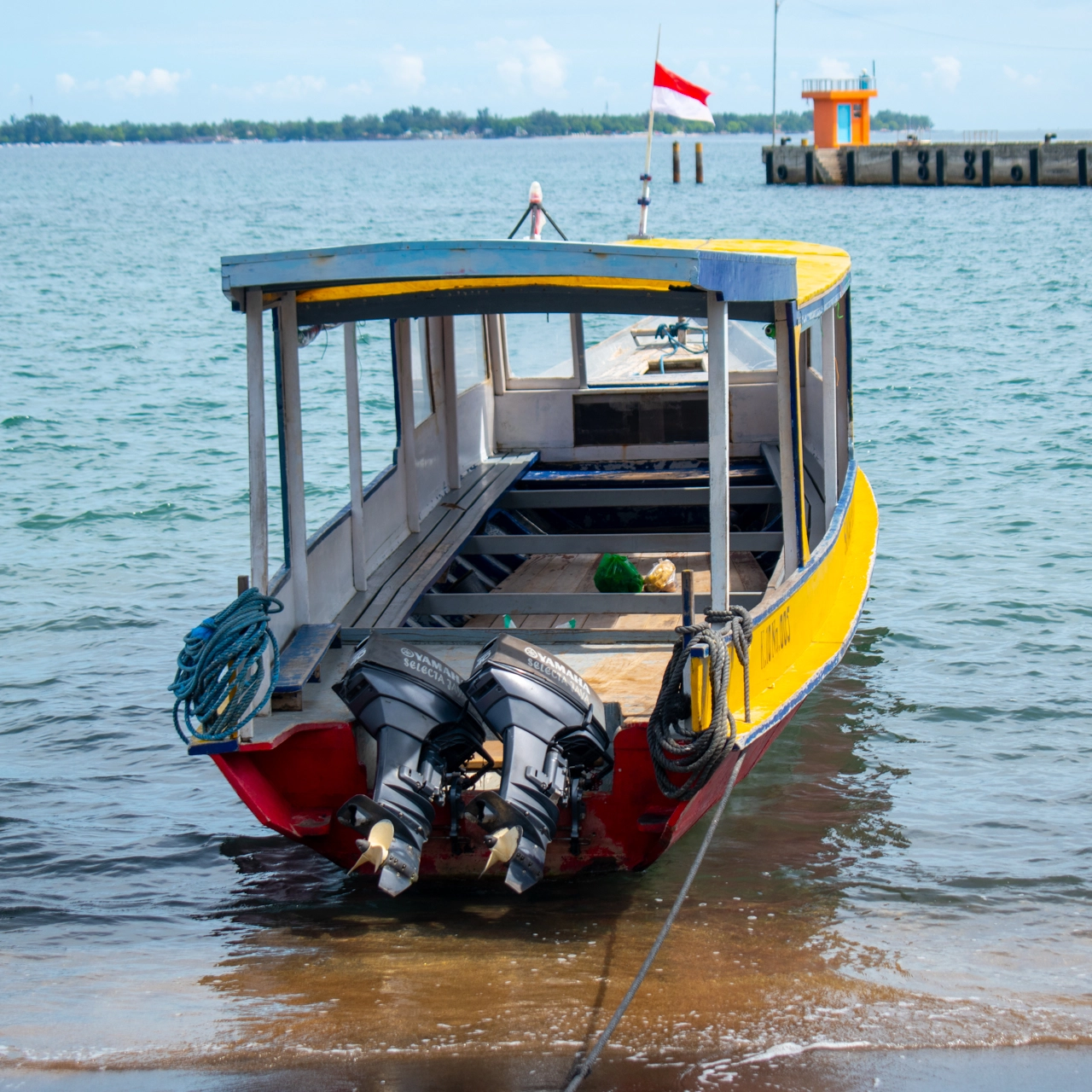 yellow boat with indonesian flag